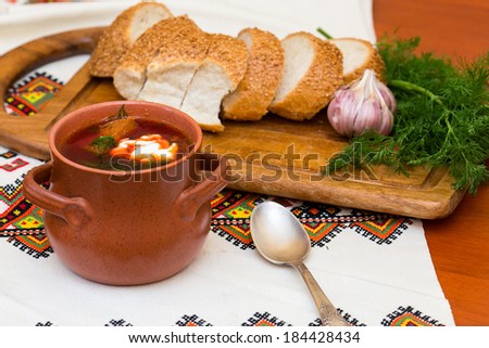 Ukrainian soup and bread with vegetables on embroidered towel