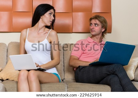 Young couple looking at a computer instead of socializing and love