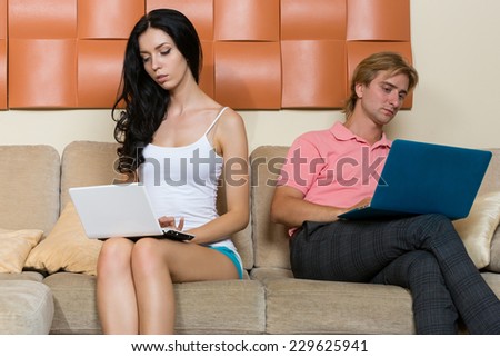 Young couple looking at a computer instead of socializing and love