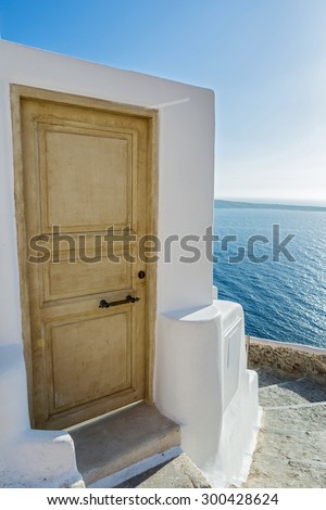 Stairs and door which go down to sea of Santorini, Greece