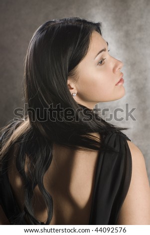 Profile of a beautiful woman in a black dress.