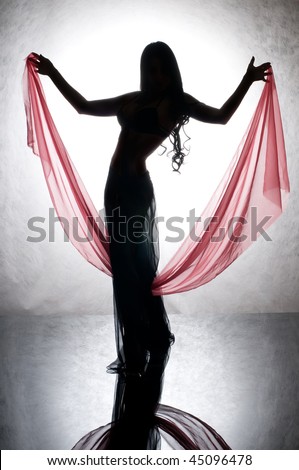 Silhouette of a dancing woman with a red silk in your hand.