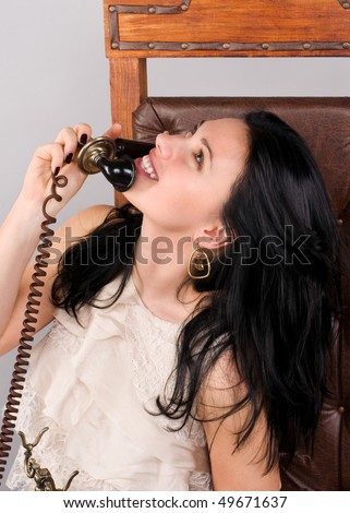 Beautiful woman speaks by ancient phone
