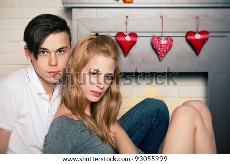 Young couple sitting by the fireplace in the st. Valentine\'s day
