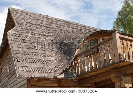 Balcony in rural wooden house with traditional wooden roof