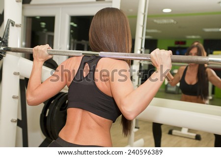 In the gym - girl is exercising in the gym