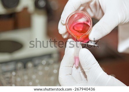 Hands with laboratory equipment - medical and chemical instruments