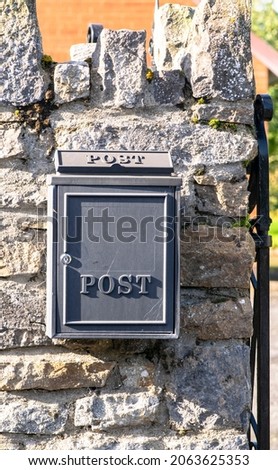 Mailboxes mounted at entry gates, mailboxes embedded in a stone wall, stylish mailboxes.