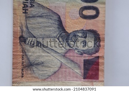 Closeup figure of KAPTEN PATIMURA - one of Indonesia hero on the Rp 1000 bill cash. Money concept of Indonesia currency paper money. Vertical captured of a little wrinkled paper one thousand rupiah. Stok fotoğraf © 