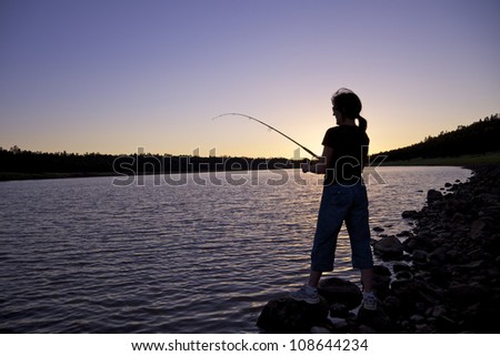 Woman Fishing at Sunset