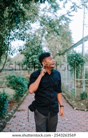 Similar – Image, Stock Photo Contemplative Asian man leaning on hand against brick building