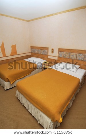 Twin beds neatly done up in a high class hotel room. Suitable for concepts such as travel, tourism, vacation and holiday.