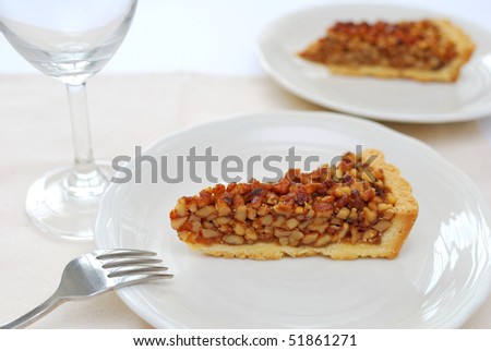 A single slice of hazel nut tart on white plate. For concepts such as food and beverage, diet and nutrition, and healthy eating.