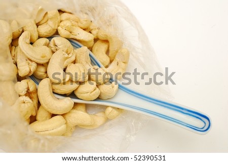 Spoonful of cashew nuts. Signifying food and beverage, and healthy and nutritious eating.