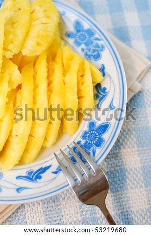 Freshly cut pineapple fruit slices signifying diet and nutrition, food and beverage, and healthy eating concepts.