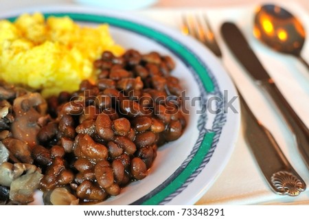 Seasoned beans and other side dishes at restaurant.