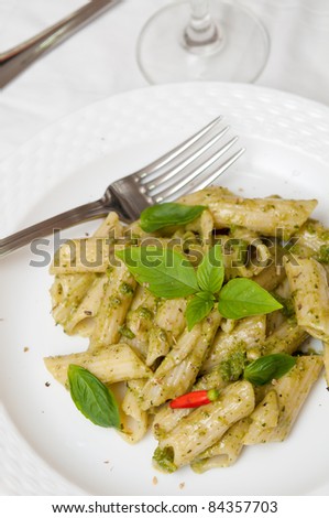 Special pasta cooked with green pesto sauce and finished with spices.