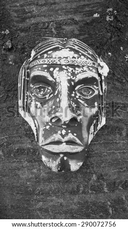 Old mask on a wooden background
