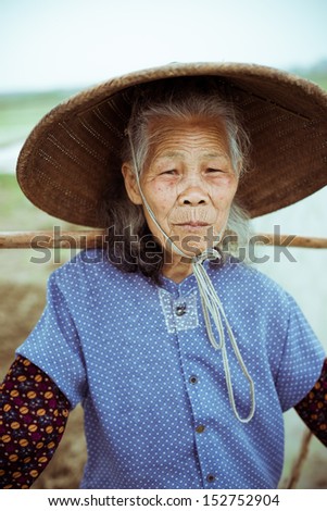 Chinese peasant working on the rice field