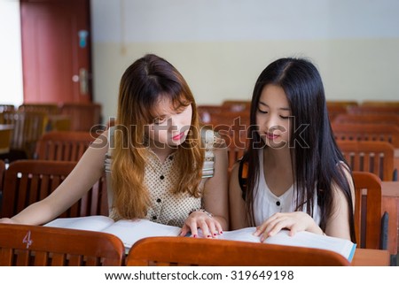 Asian female college students to study in classroom