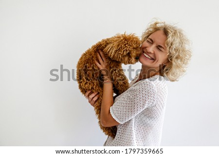 Similar – Image, Stock Photo Caucasian woman holding puppy. Adopted border collie dog held by a caucasian woman with long blond hair. Friendship and family.