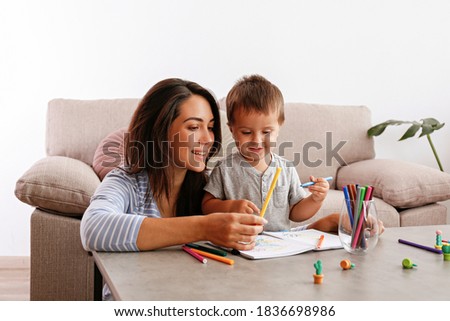 Similar – Image, Stock Photo A young mother teaches her little daughter to draw with colored pencils. Time together, creativity, education. Side view