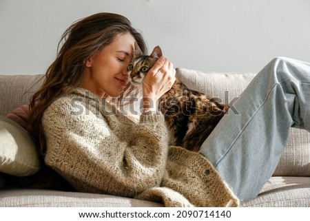 Similar – Image, Stock Photo Young woman hugging cat in hallway