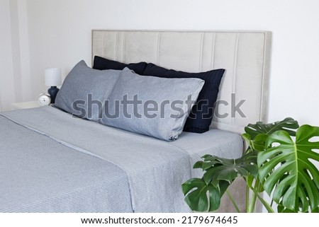 Similar – Foto Bild Das Bett ist mit sauberen weißen Kissen und Bettwäsche im Zimmer ausgestattet.