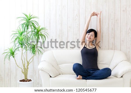 a young asian woman stretching in the room