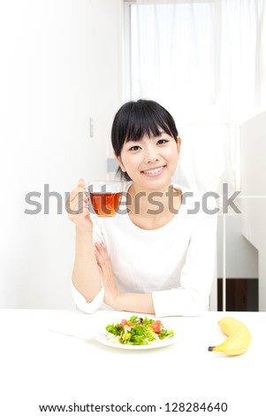 attractive asian woman eating vegetable salad