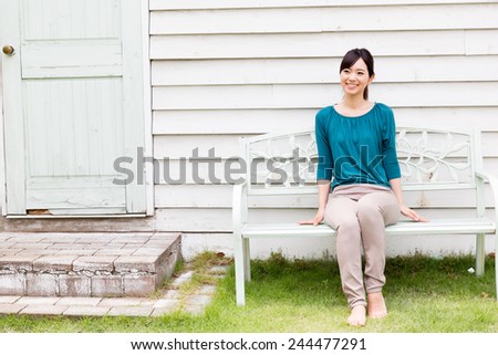 young asian woman relaxing in the garden
