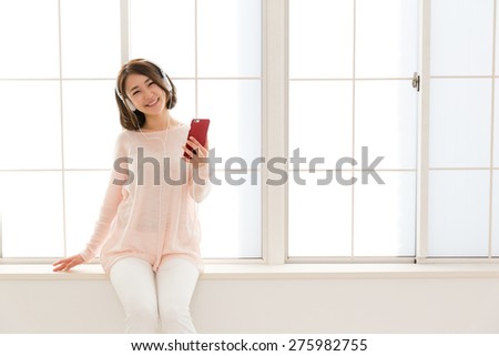 young asian woman listening music