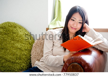 beautiful asian woman reading a book