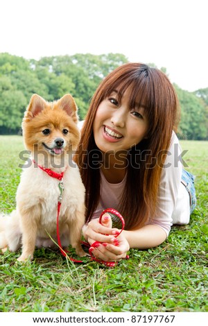 beautiful asian woman with dog in the park