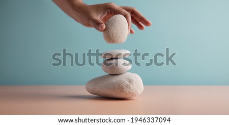 Life Balance Concept. Hand Setting White Natural Zen Stone Stack. Balancing Mind, Soul and Spirit. Mental Meditation Practice
