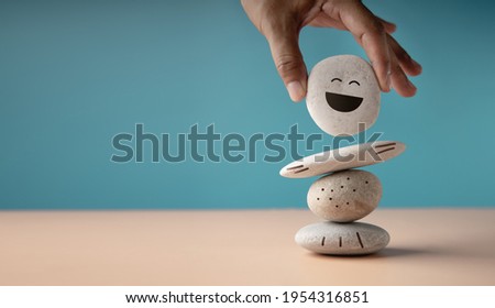 Photo of Enjoying Life Concept. Harmony and Positive Mind. Hand Setting White Natural Stone Stack to Balance. Balancing Body, Mind, Soul and Spirit. Mental Health Practice