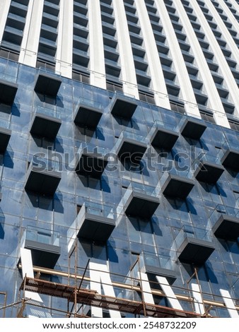 Similar – Image, Stock Photo High-rise building completely scaffolded