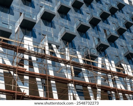 Similar – Image, Stock Photo High-rise building completely scaffolded