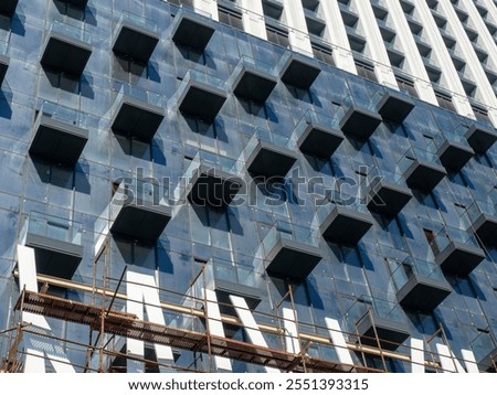 Similar – Image, Stock Photo High-rise building completely scaffolded