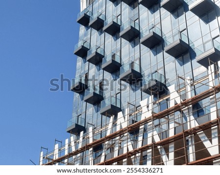 Similar – Image, Stock Photo High-rise building completely scaffolded