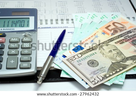 composition - pen, calculator and banknote