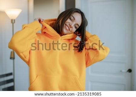 Similar – Image, Stock Photo Woman in yellow hoodie taking selfie on smartphone on rocky shore