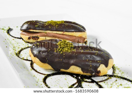 Prepared for special occasions, delicious and beautiful chocolate small cake ekler pastry, isolated on white background Stok fotoğraf © 