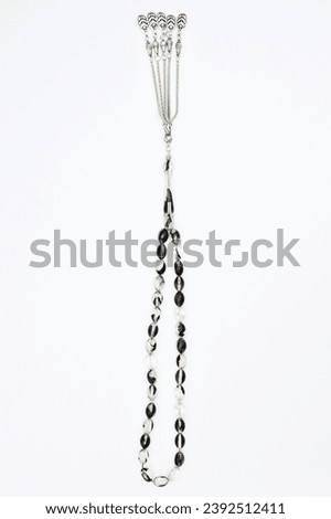 Similar – Image, Stock Photo A rosary hangs from an open Christian prayer book with the Our Father