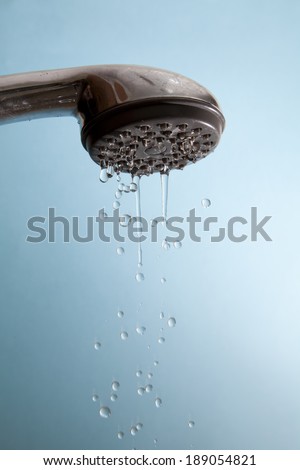 A shower head dripping water.