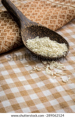 Wooden spoon, rice, cereals, cotton, texture, background.