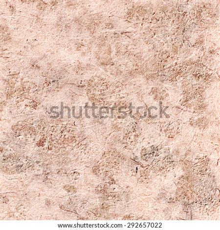 Close-up of Handmade fiber organic paper texture with umbels and seeds. Beige background. Craft eco recycle textured paper. Useful for scrapbooking and greeting or oriental cards. Mulberry, Sa paper.