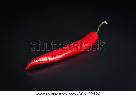 Red chili pepper isolated on a black background
