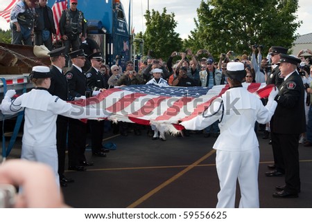 SILVERDALE, WA - AUGUST 22: The flag which accompanied the 9/11 Memorial Steel from New York to Silverdale is folded by local firefighters and Navy personnel August 22, 2010 in Silverdale.