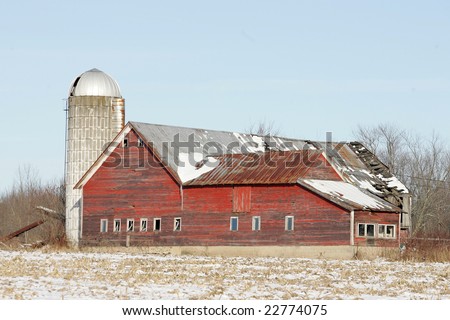 An old Red Barn and silo on a Farm during the winter